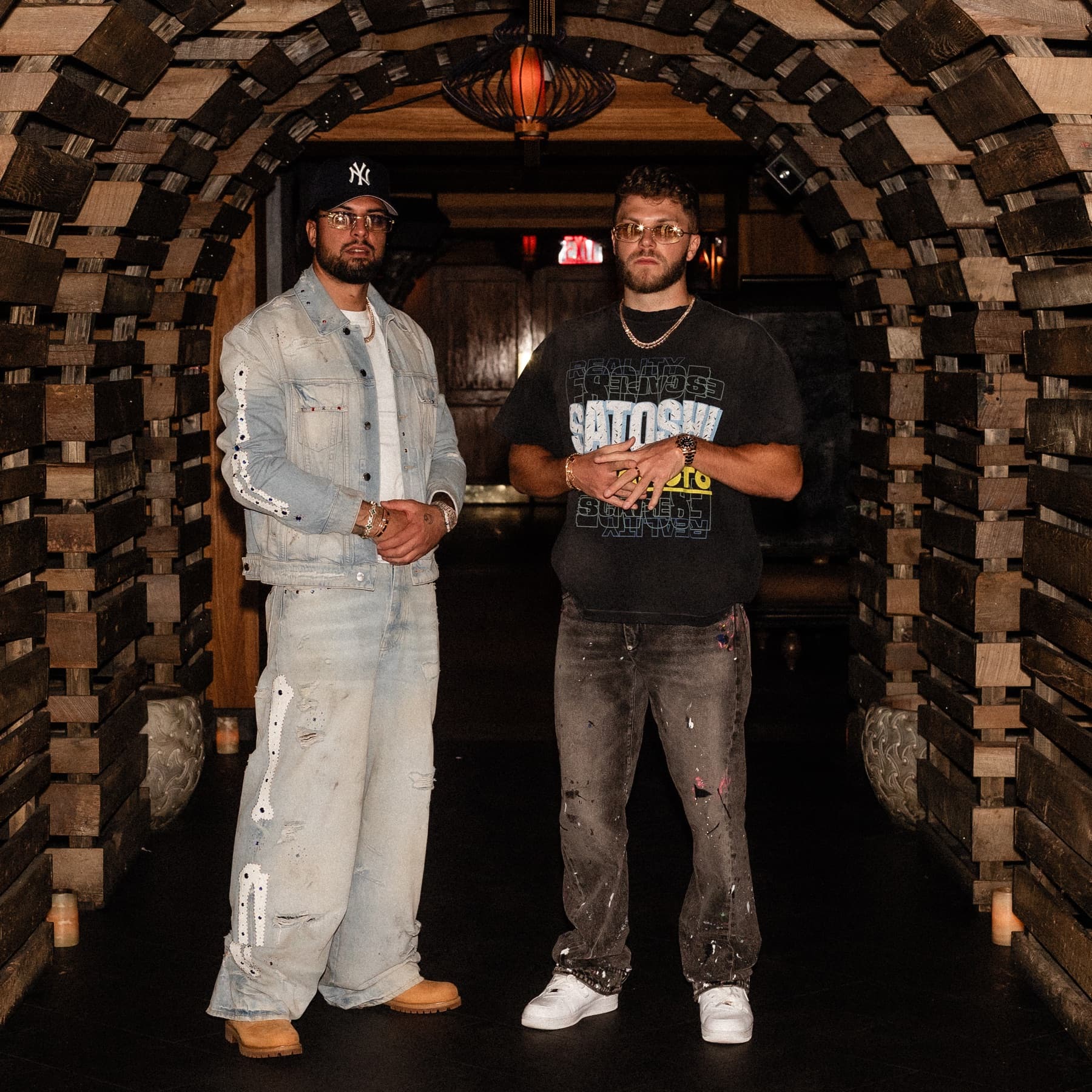David Chaboki (Shibo / GodsBurnt) and Christian Barker (Bark / Barkmeta) standing in the Bodega Negra tunnel at DDNYC 2026 in New York
